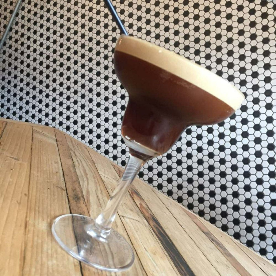 Black & White Honeycomb Floor Mosaic black and white hexagonal mosaic flooring with an espresso martini in a glass coupe