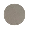 A circular matte gray stone slab with a subtly textured surface from the blends castano circle collection