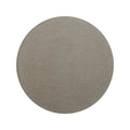A circular matte gray stone slab with a subtly textured surface from blends castano circle collection