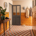 The bloomsbury red black and holkham dune floor tile features a geometric pattern with red white and gray diamond shapes