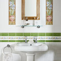 White ceramic pedestal sink with chrome faucets shown with blue iris 5-tile set on brilliant white background