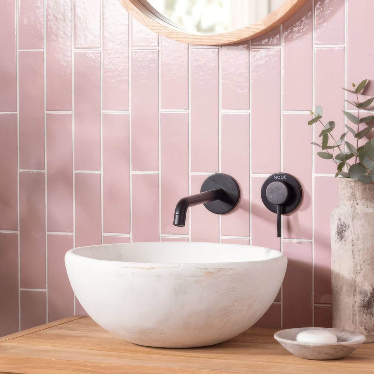 White ceramic bowl sink with matte finish and subtle texture complementing blush smooth brick tile design