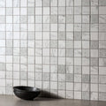 Bohemia recycled glass mosaic tile wall with white and gray marble pattern and decorative geometric accents