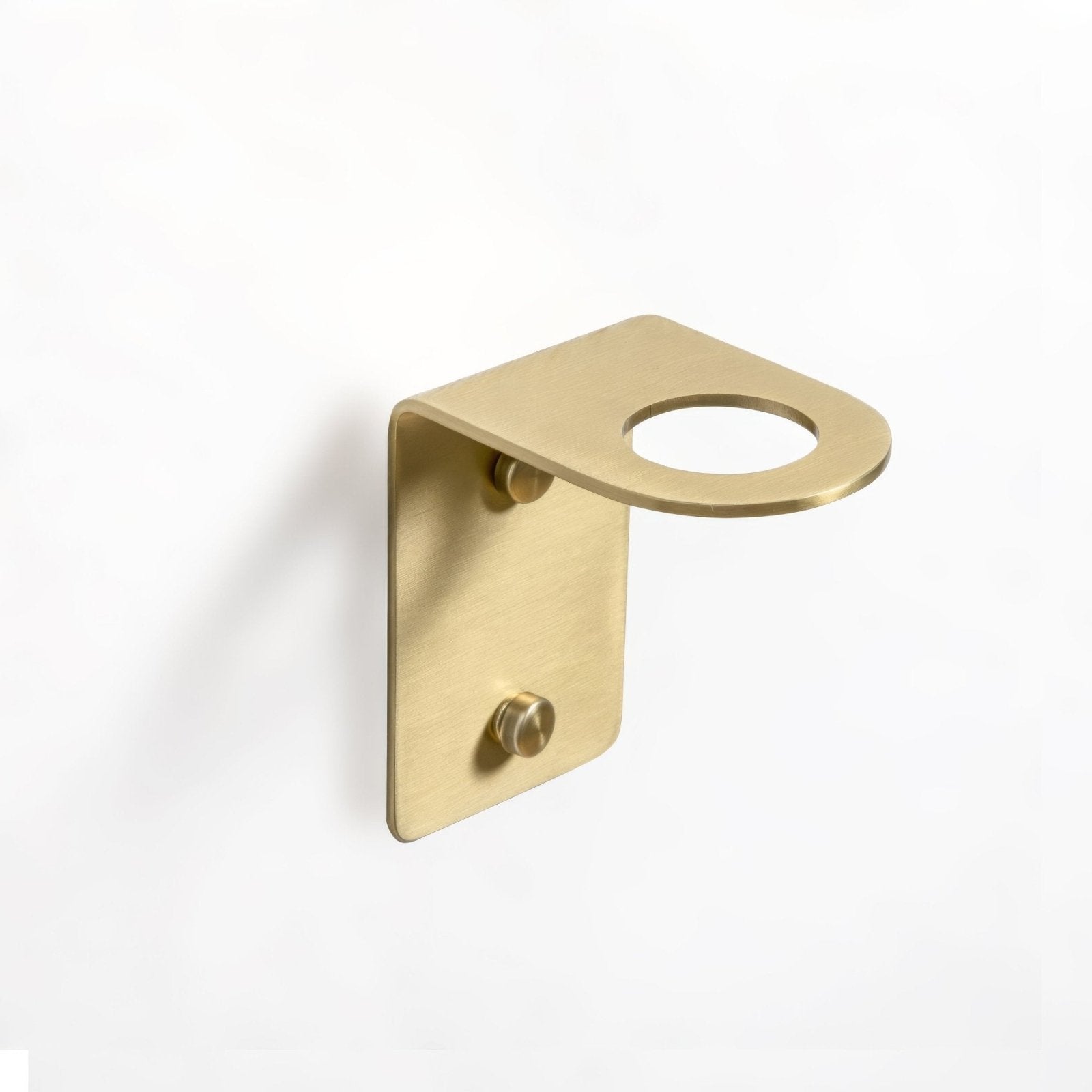 Brass wall-mounted bottle holder with one hole in brushed brass finish and two screws for secure attachment