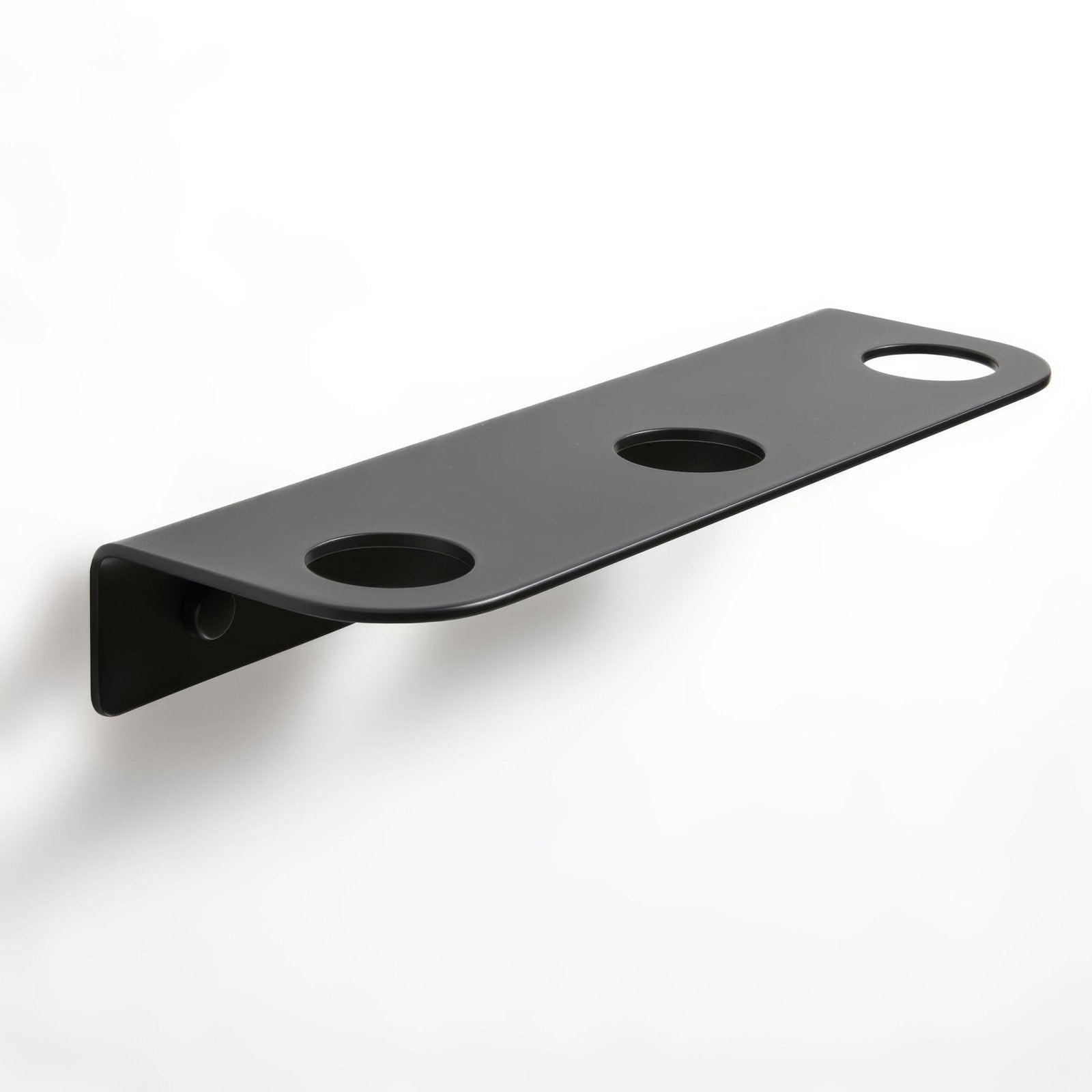 Black matte-finished metal wall-mounted bottle holder with three circular cutouts for cups or bottles