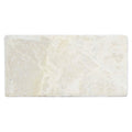 Cream-colored Bottocino tumbled marble rectangular tile 150 x 75mm with natural veining and textured surface