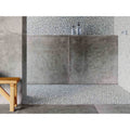 Gray textured concrete wall with pebble accent tiles in boulder grey mosaic for modern interior design