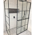 Boulder Negro Marquina Mosaic black marble pebble mosaic in a shower with a black-framed glass enclosure