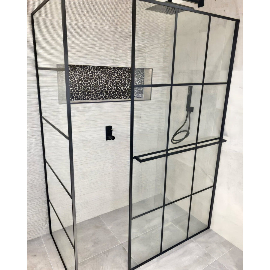 Boulder Negro Marquina Mosaic black marble pebble mosaic in a shower with a black-framed glass enclosure