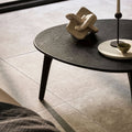 Dark wood oval coffee table with sleek tapered legs in bourgogne beige finish for stylish living spaces