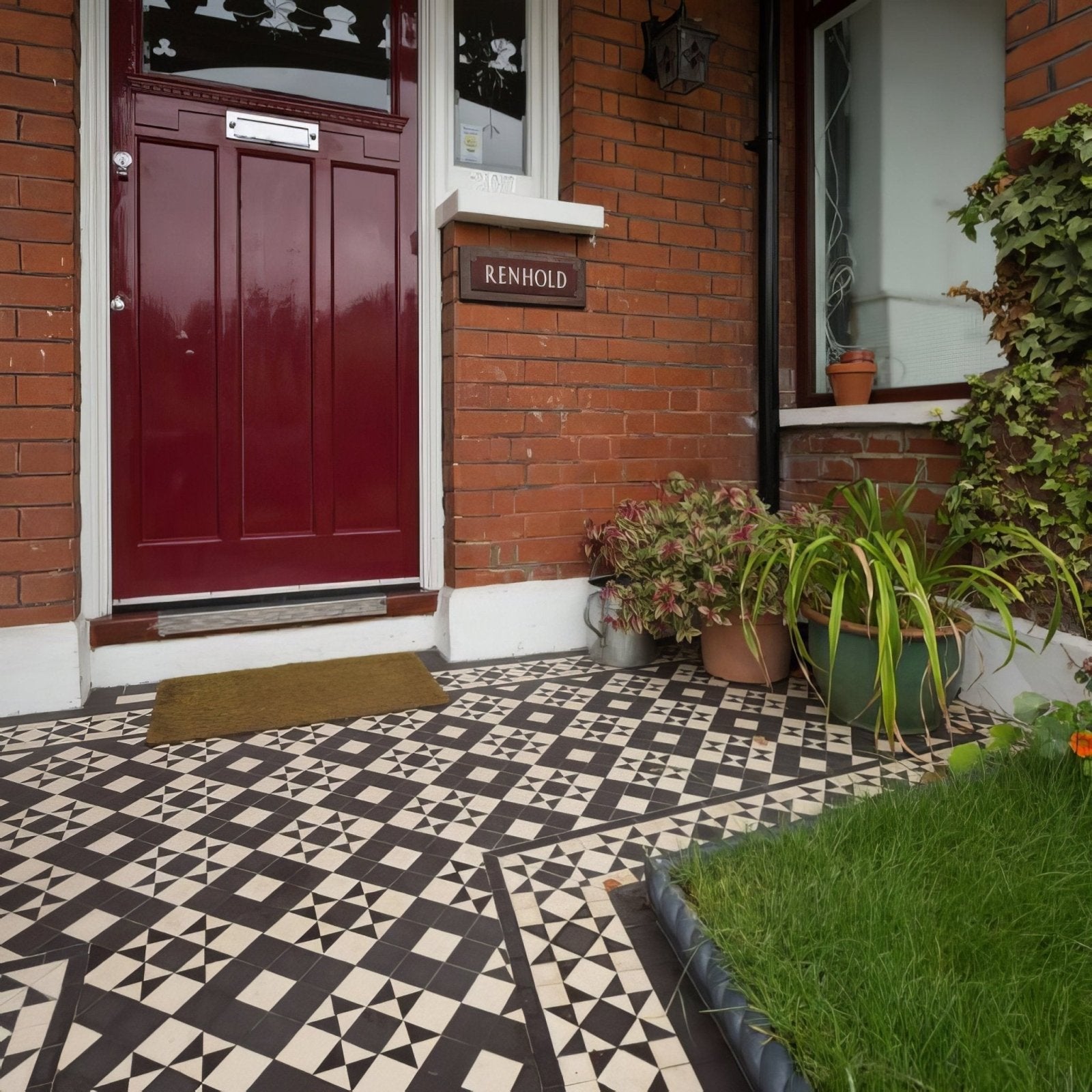 The braemar black and white front door features rich burgundy vertical paneling with a silver mail slot