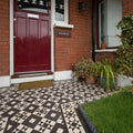 The braemar black and white front door features rich burgundy vertical paneling with a silver mail slot