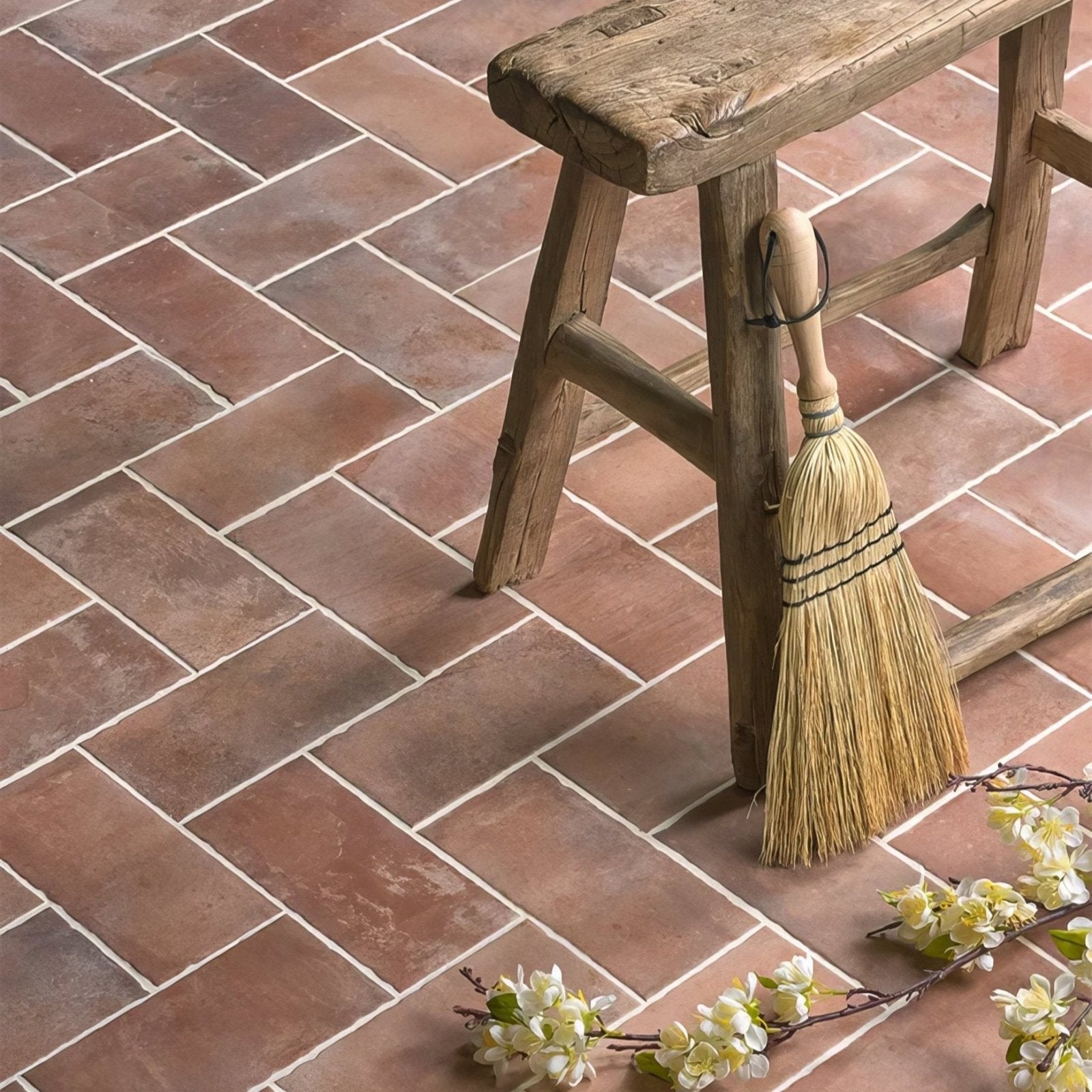 A rustic wooden stool with weathered finish and sturdy construction paired with brewhouse porcelain brick background
