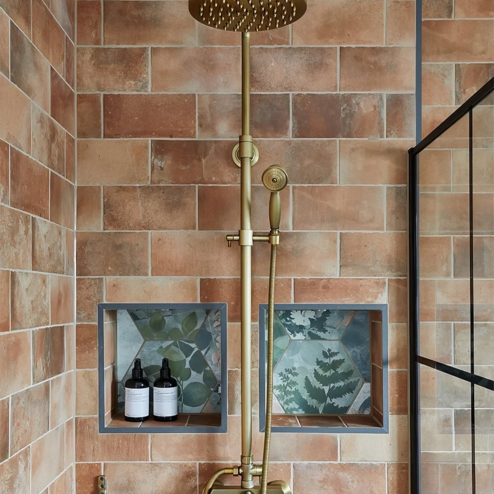 Brass showerhead with round perforated design and matching handheld attachment in brewhouse porcelain brick finish
