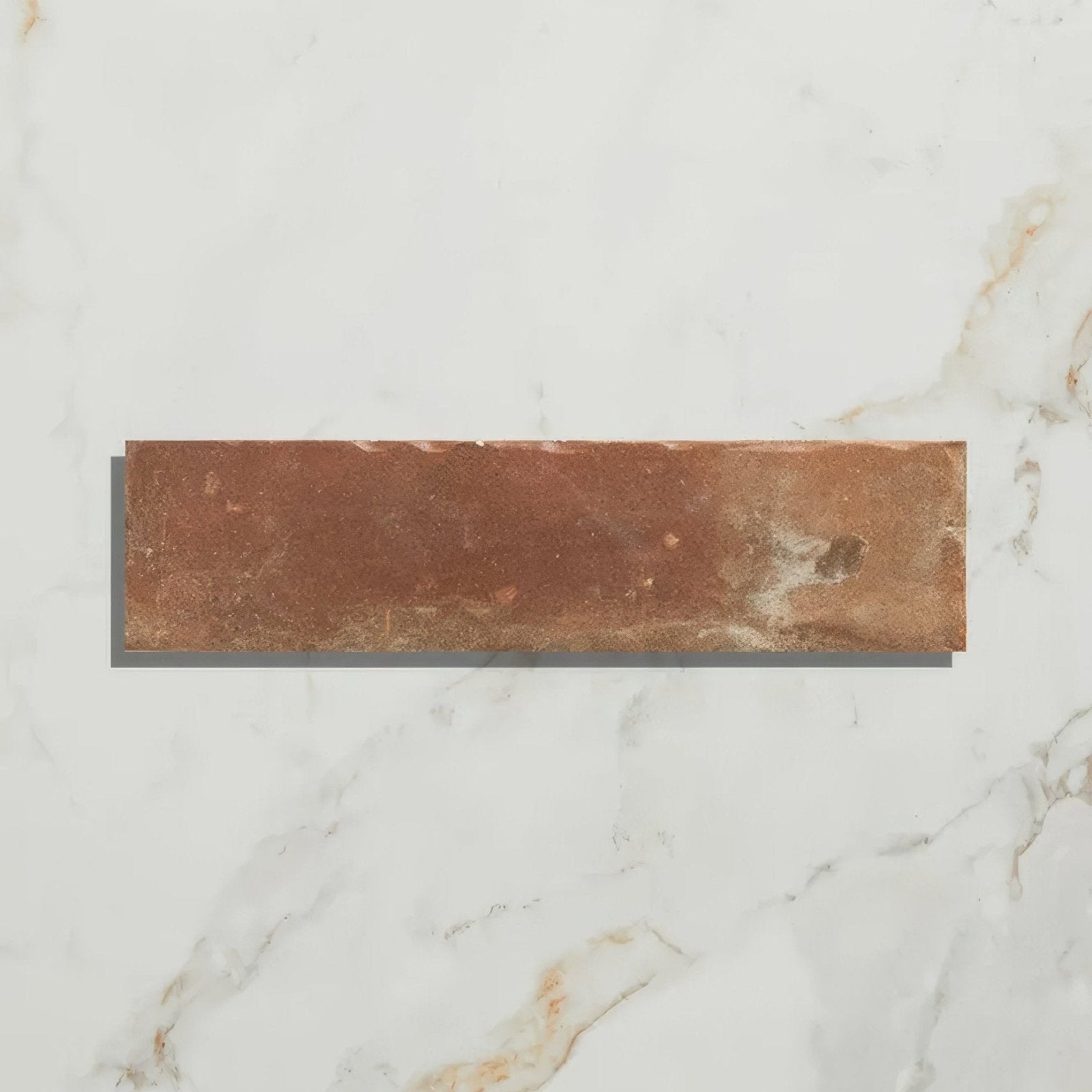 A rustic rectangular brewhouse porcelain parquet tile in terracotta with warm brown hues and natural tone variations