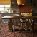 Rustic wooden dining table brewhouse porcelain parquet with thick dark-stained pedestal base and smooth light-toned top