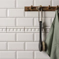 Brilliant white dentil moulding with black-handled bath brush with natural bristles hanging on wooden rack