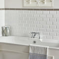 Brilliant white metro bevelled tile with a subtle textured finish for white subway tile backsplash use