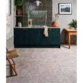 Brit stone burford porcelain 60 x 90cm with dark green shaker-style kitchen cabinets brass handles and marble countertop