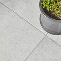 Brit stone minster porcelain paving gray stone-effect patio tiles with subtle texture and dark grout lines