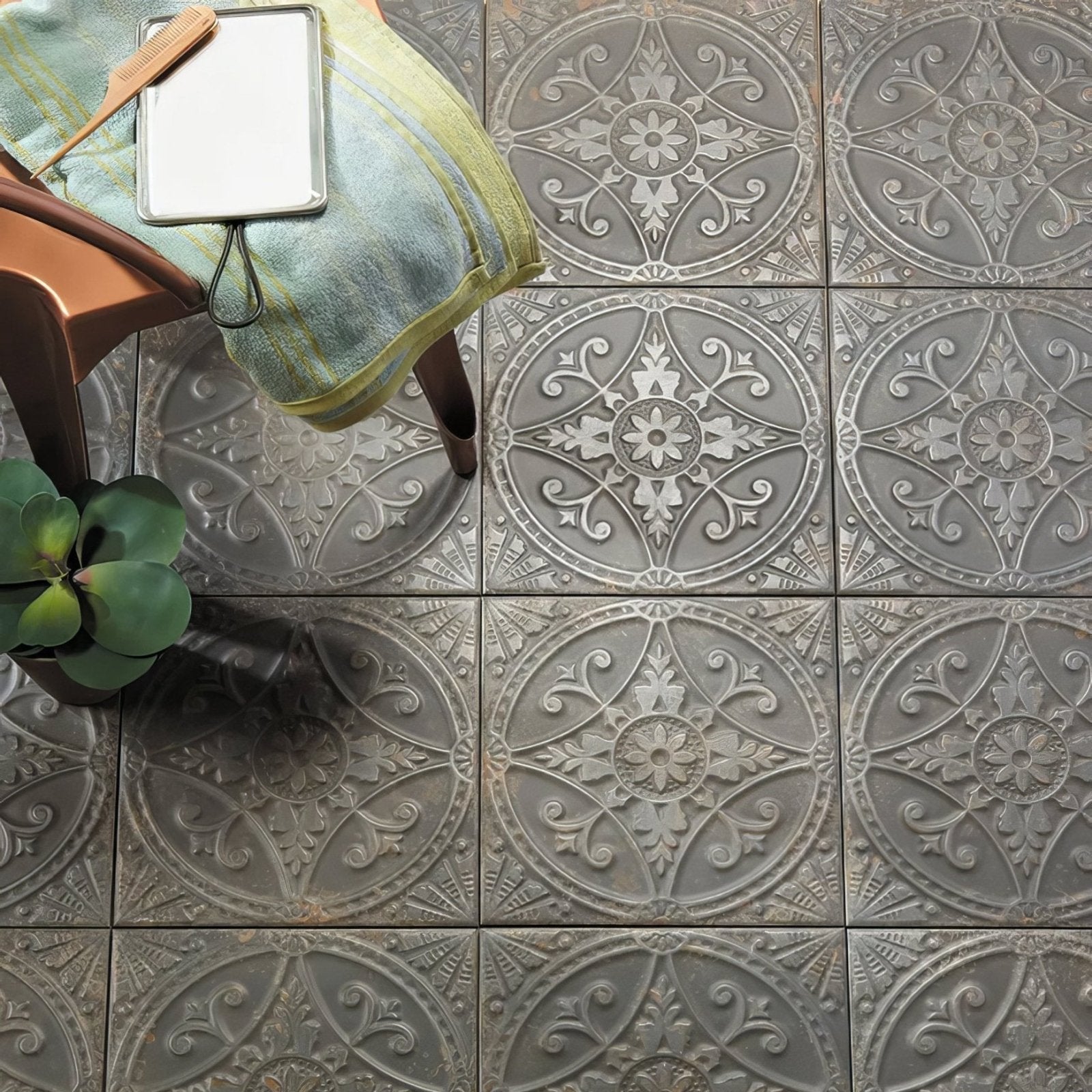 Gray decorative ceramic pewter tiles with intricate floral and scrollwork embossed patterns for interior design