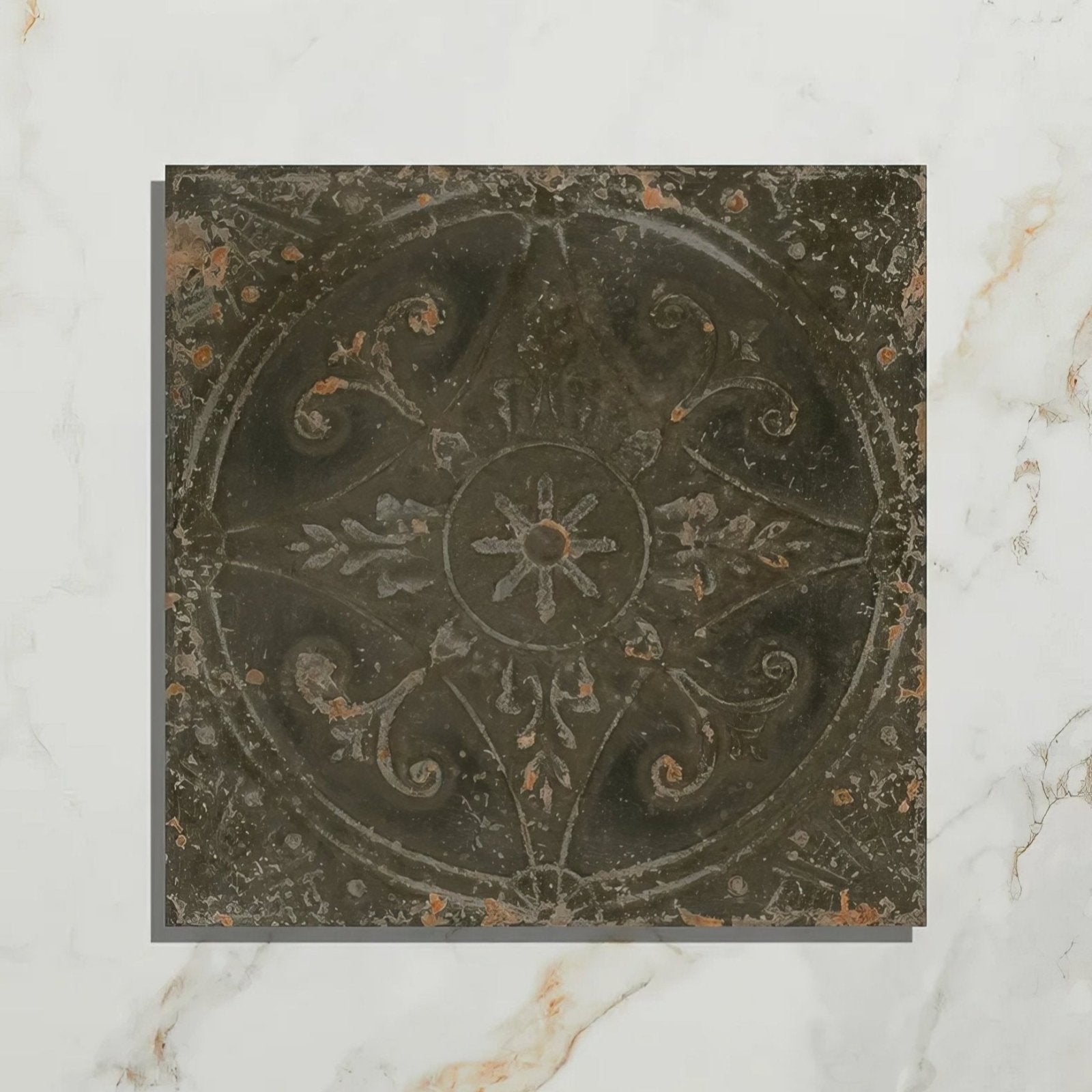 Antique-style brooklyn embossed ceramic pewter floor tile in dark gray metal with intricate floral and starburst patterns