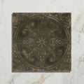 Antique-style brooklyn embossed ceramic pewter floor tile in dark gray metal with intricate floral and starburst patterns