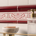 Burgundy albert moulding red and white ceramic tile with ornate floral and ribbon decorative motifs