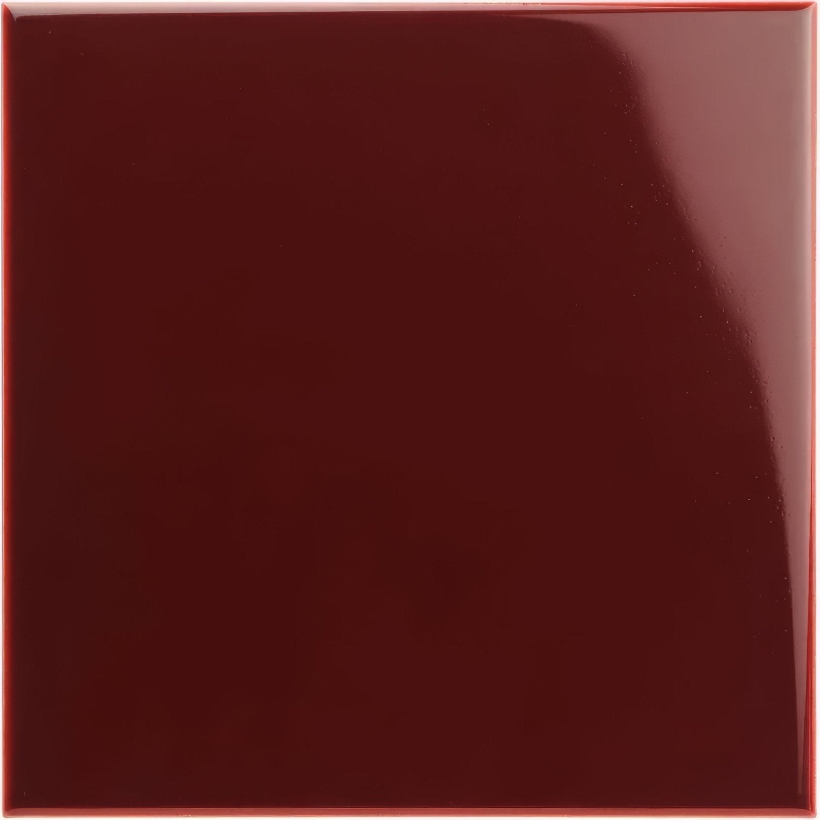 A glossy deep burgundy square field tile with a smooth reflective surface for interior wall and floor use