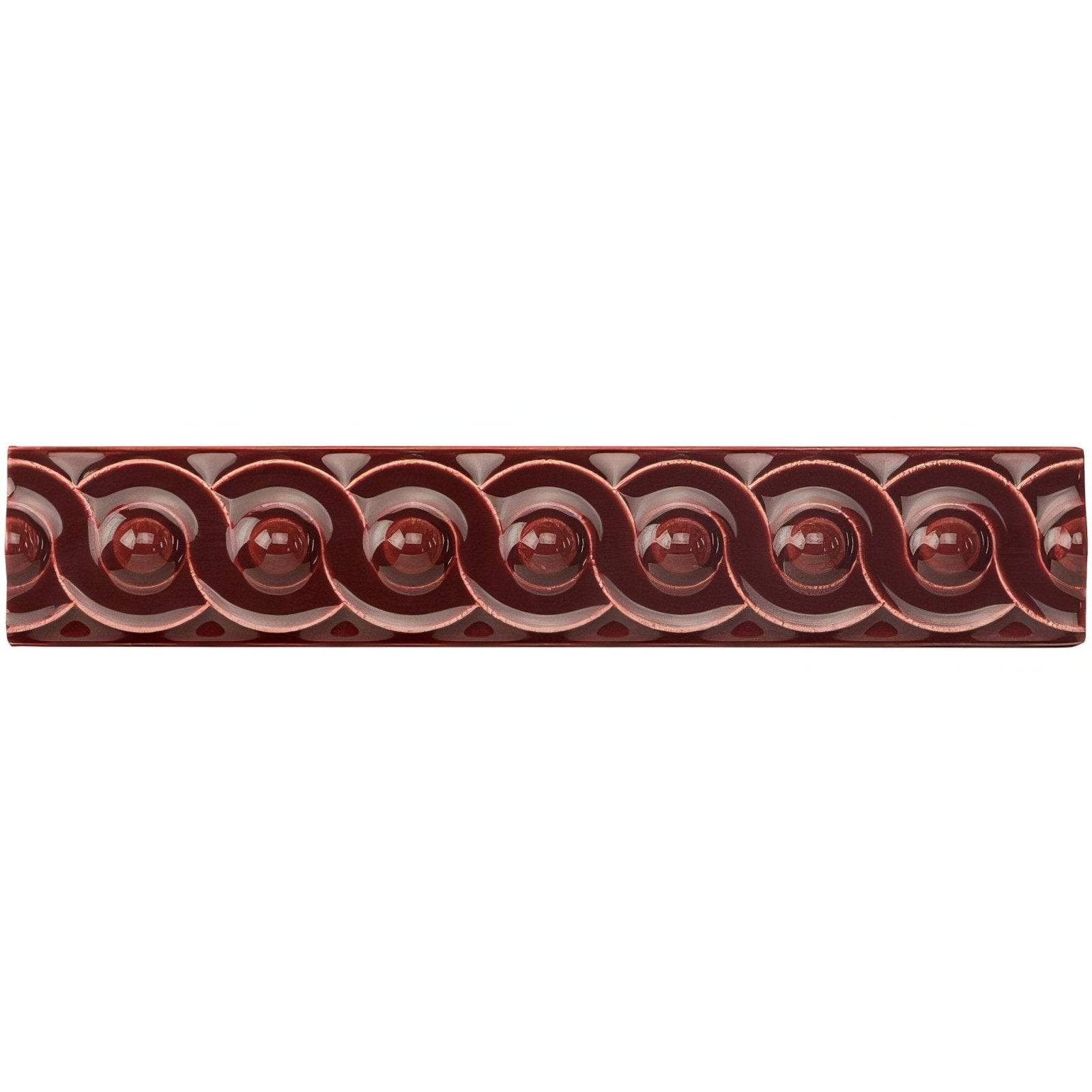 A glossy burgundy ceramic tile with raised interlocking circular motifs in a burgundy scroll moulding pattern