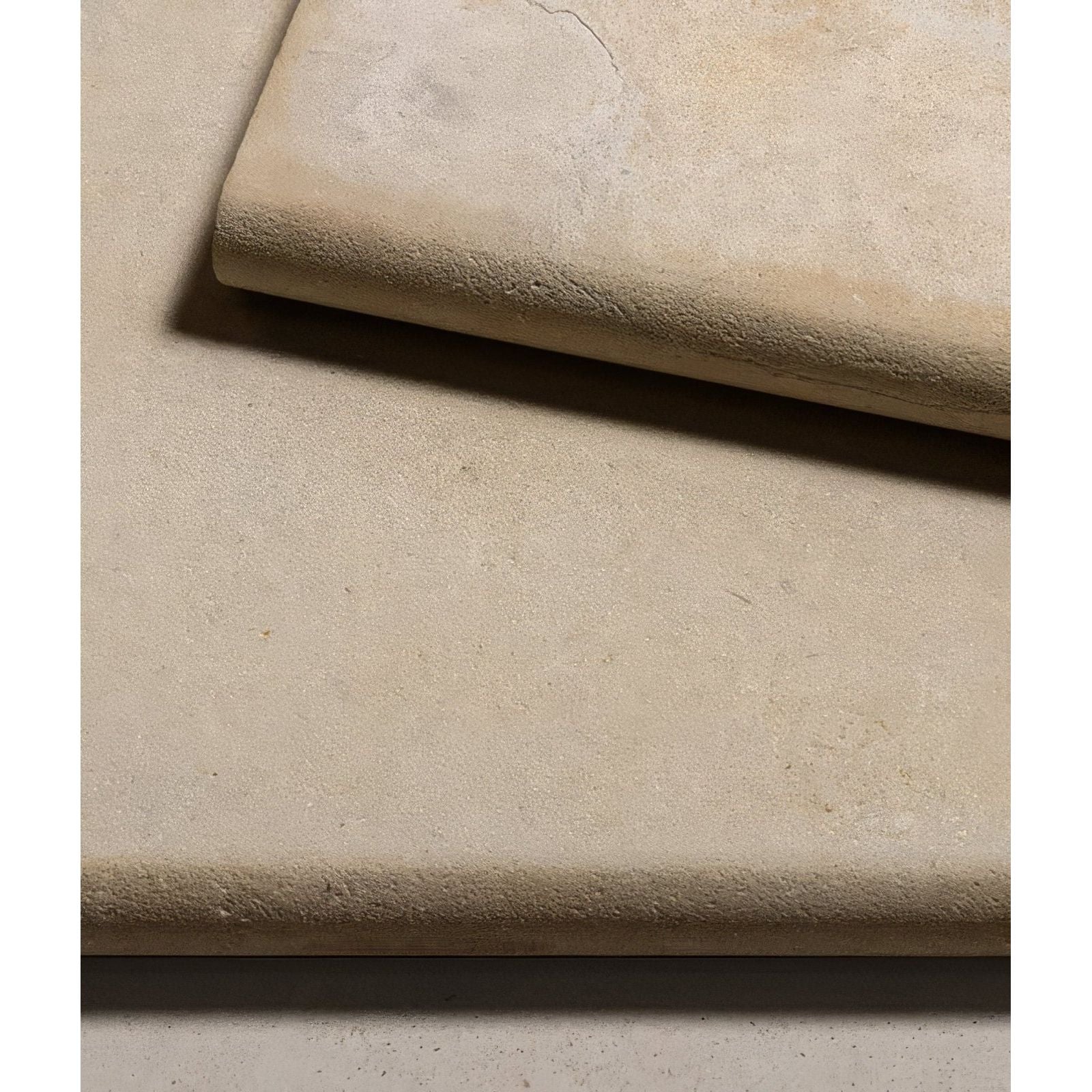 Beige textured stone tiles with a subtle natural finish from buscot limestone etched bullnose coping collection