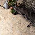 Beige Buscot porcelain parquet textured stone tiles with herringbone pattern and subtle natural veining