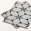 Black and white marble mosaic tiles with geometric floral pattern made of porcelain for decorative flooring