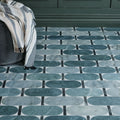Byzantine porcelain lauro sculpted teal and white marble effect oval floor tiles with black grout lines