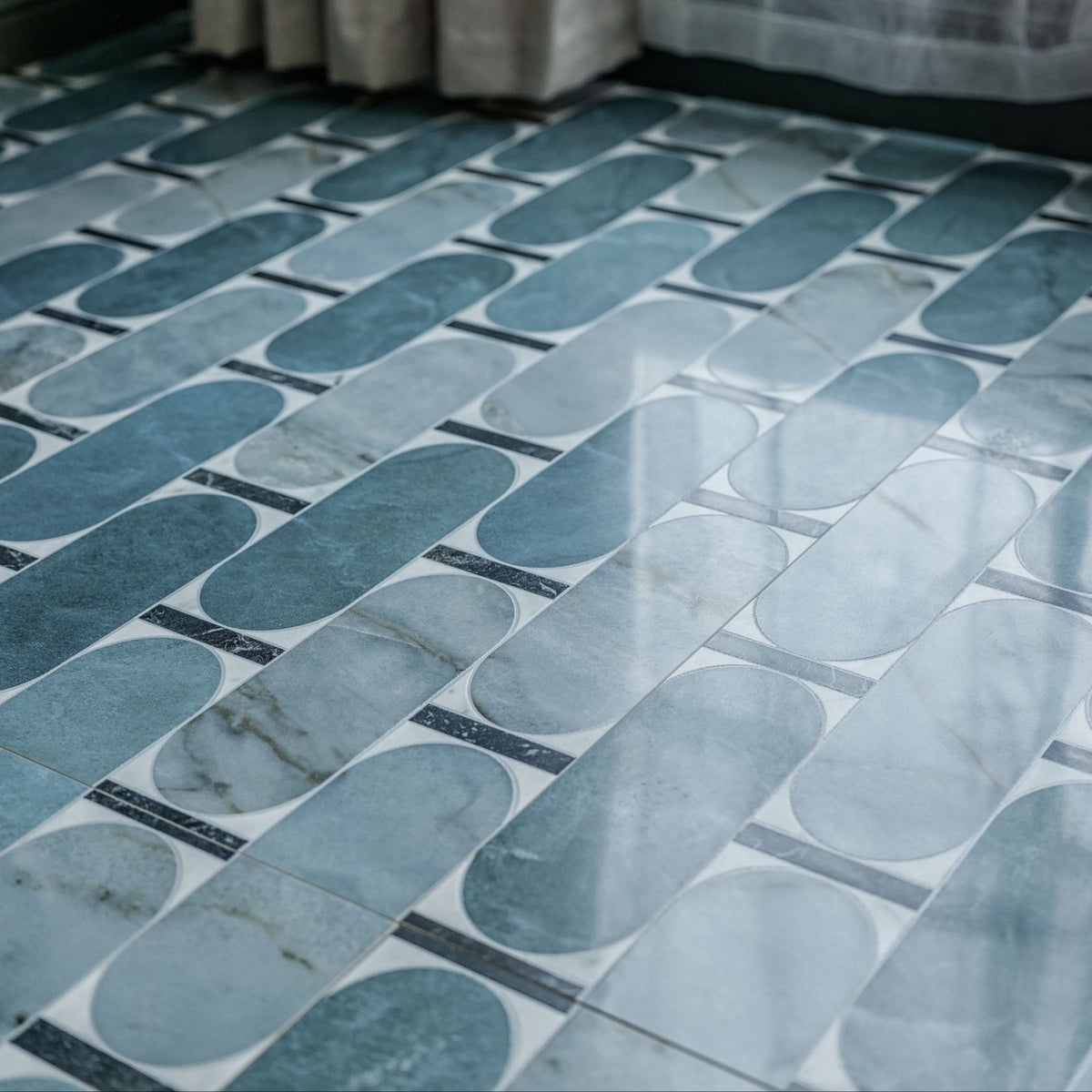 Byzantine porcelain lauro sculpted blue and white marble patterned oval floor tiles arranged in geometric design