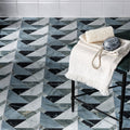 Geometric marble floor tiles in black white and gray arranged in a herringbone pattern from byzantine porcelain seraph sculpted collection