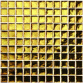 Byzantium gold glass mosaic of golden metallic square tiles with a reflective textured surface for decorative use