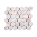 Calacatta Sugar tumbled marble hexagon mosaic sheet in white marble with warm gold veining and softened edges