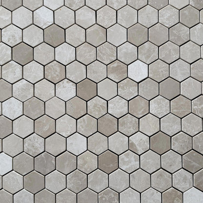 Close detail of polished Belgravia Beige marble hexagons showing warm sand tone and taupe drift