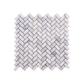 Sheet of Carrara White tumbled marble herringbone mosaic with softened edges and fine grey veining