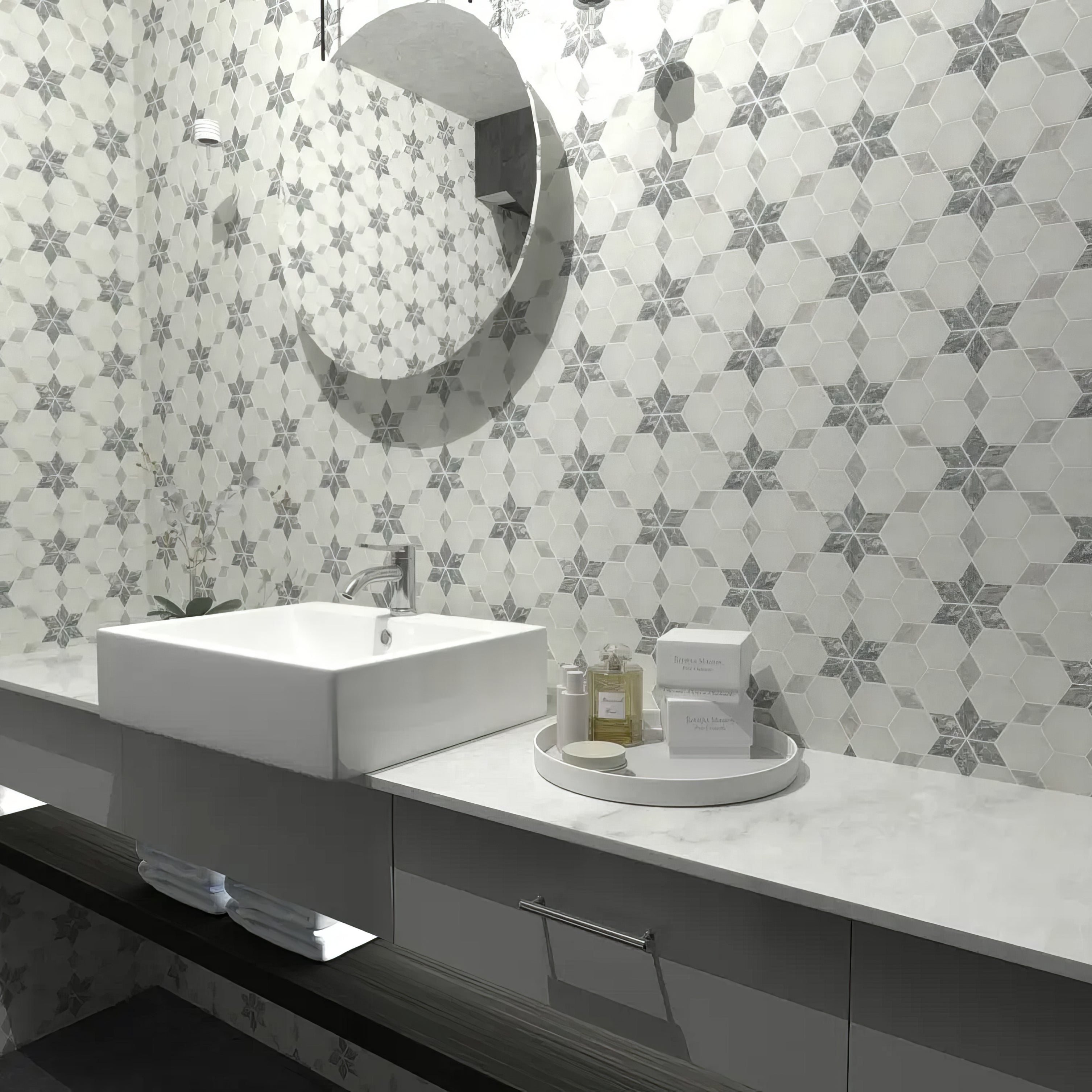 Close detail of grey marble star points set into honed Carrara White in the starline mosaic