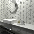 Close detail of grey marble star points set into honed Carrara White in the starline mosaic
