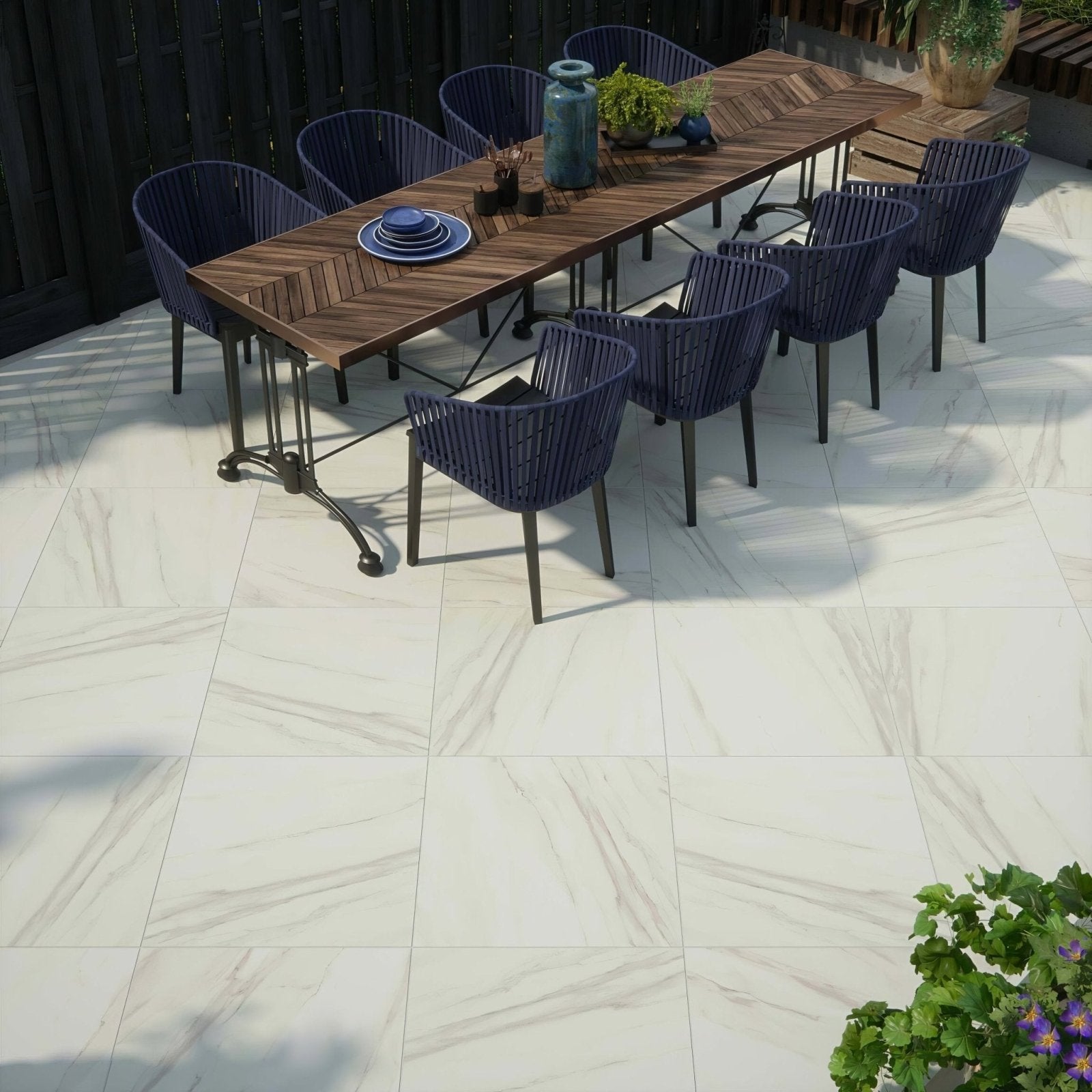 Dark blue woven resin outdoor dining set with wooden table and metal legs on calacatta gold matt porcelain paving