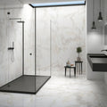 Calacatta Gold Polished Porcelain Tiles white marble-effect porcelain tiles in a black-framed glass shower enclosure