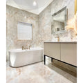 California Porcelain Beige beige marble-effect tiles with a ribbed white freestanding bathtub
