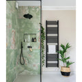 California Porcelain Jade green marble-effect tiles with a black rain showerhead