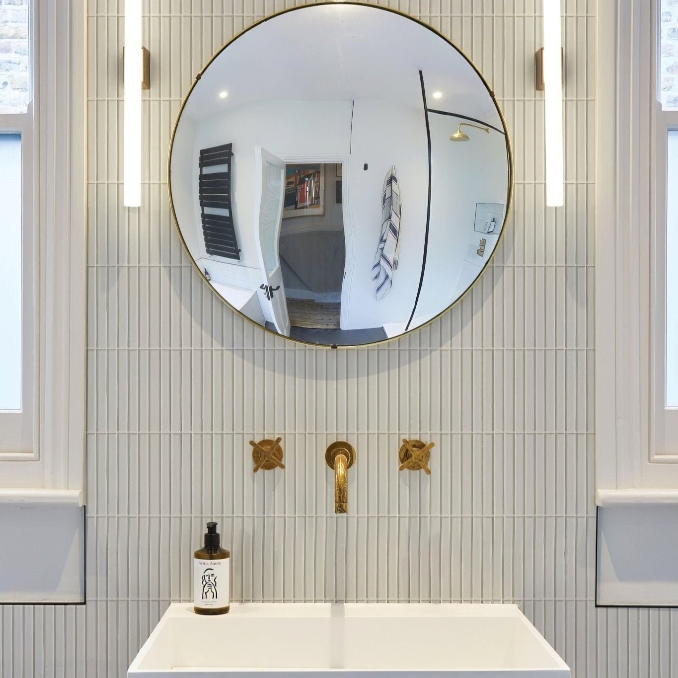 Round gold-framed mirror with candy cane porcelain mosaic peppermint design in festive red and white colors