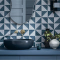 Dark gray matte ceramic vessel sink with a sleek rounded bowl shape featured in capri ocean hand painted tile design