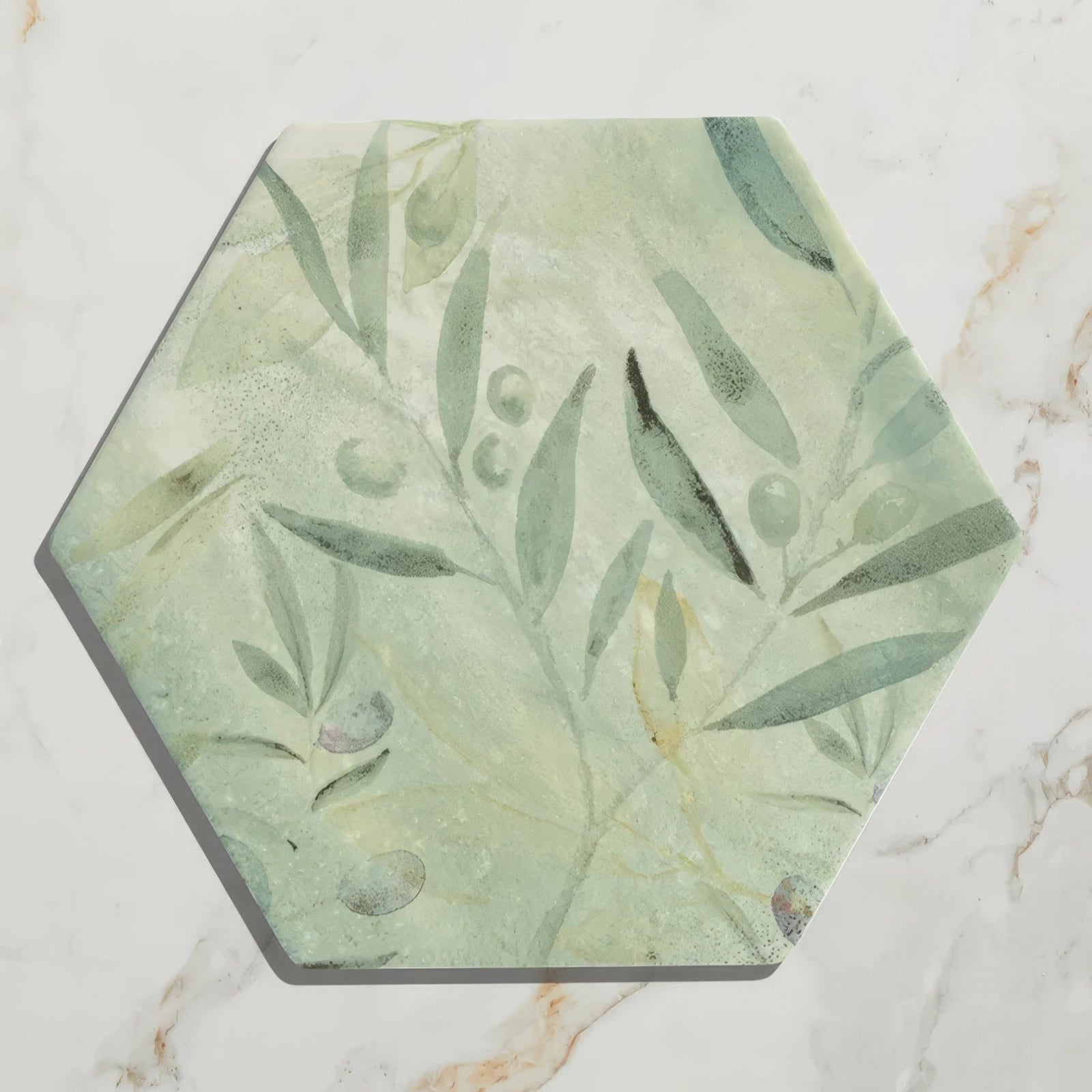 Capri porcelain hexagonal tile with soft green and white olive branch pattern and subtle texture in muted tones