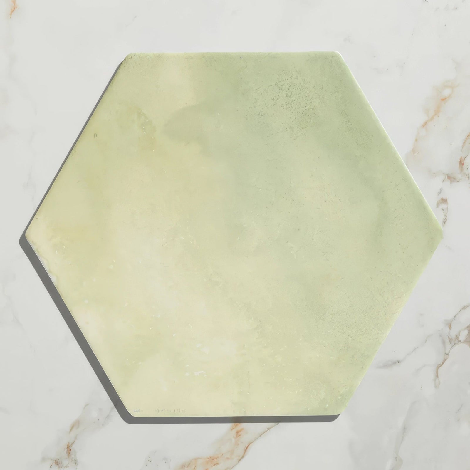 A hexagonal capri porcelain tile with soft pale green marble finish for elegant flooring and wall decor